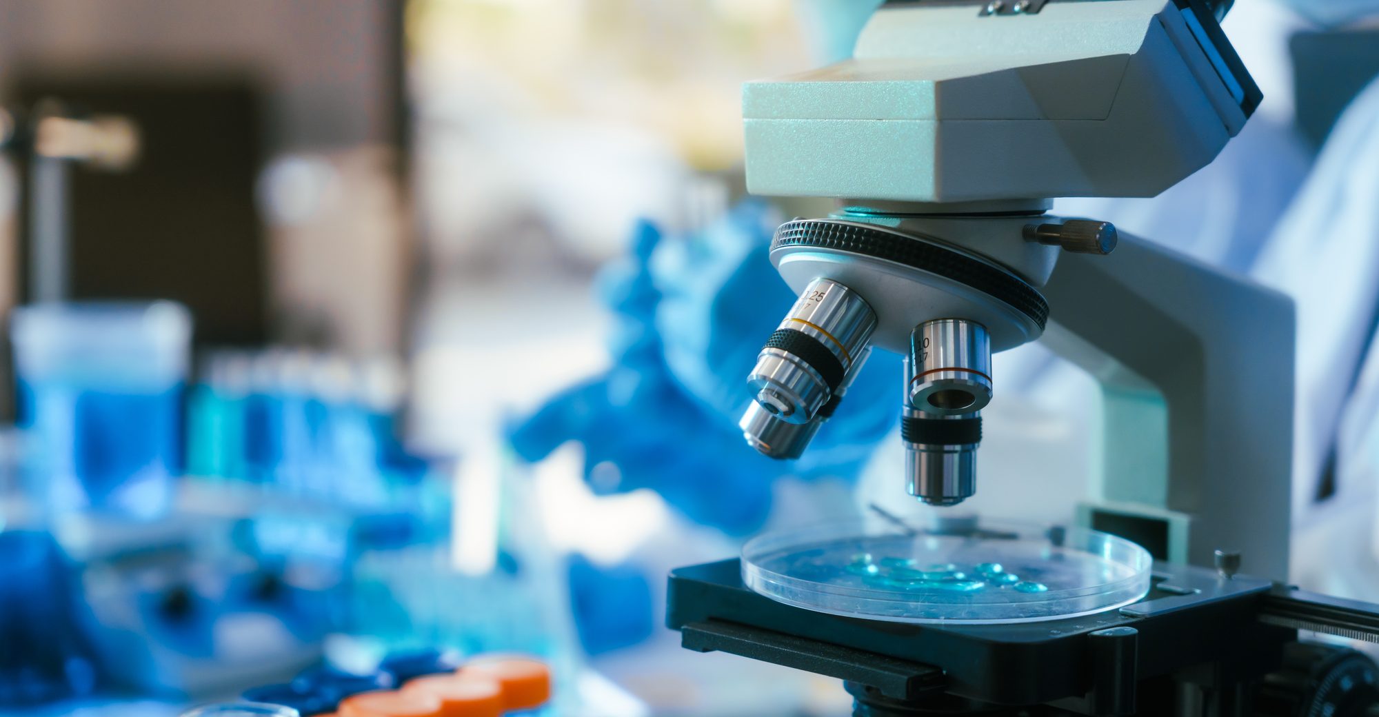 A researcher looking through a microscope in a laboratory